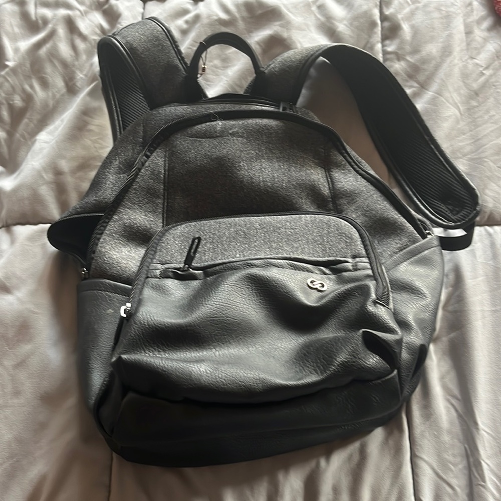 Super cute, gray and faux black leather backpack. Women’s.